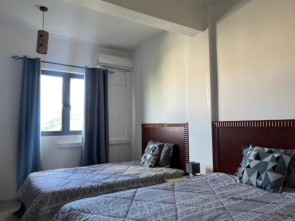 Postel nebo postele na pokoji v ubytování Fortuna Beach