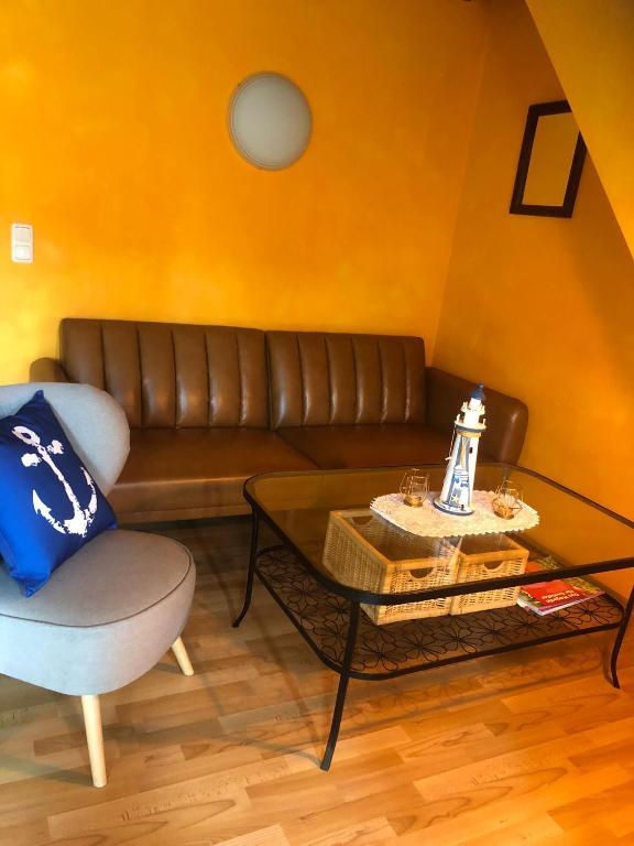 a living room with a couch and a coffee table at Maisonettewohnung auf 2 Etagen mit zwei Balkonen in Barth
