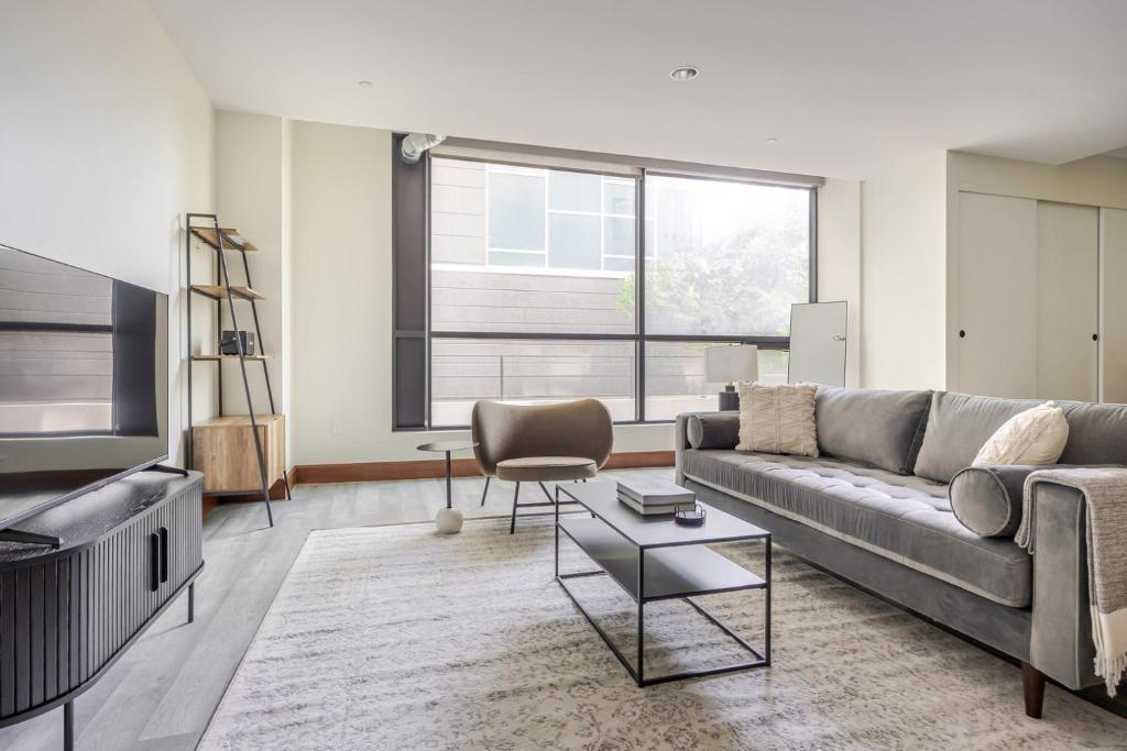 a living room with a couch and a tv at Blueground Waterfront view nr Long Beach LAX-1365 in Los Angeles