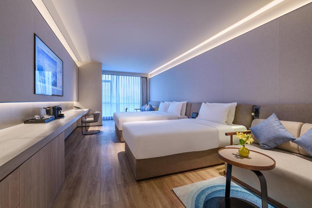Postel nebo postele na pokoji v ubytování Qingdao Shandong Road Mixc Orange Crystal Hotel