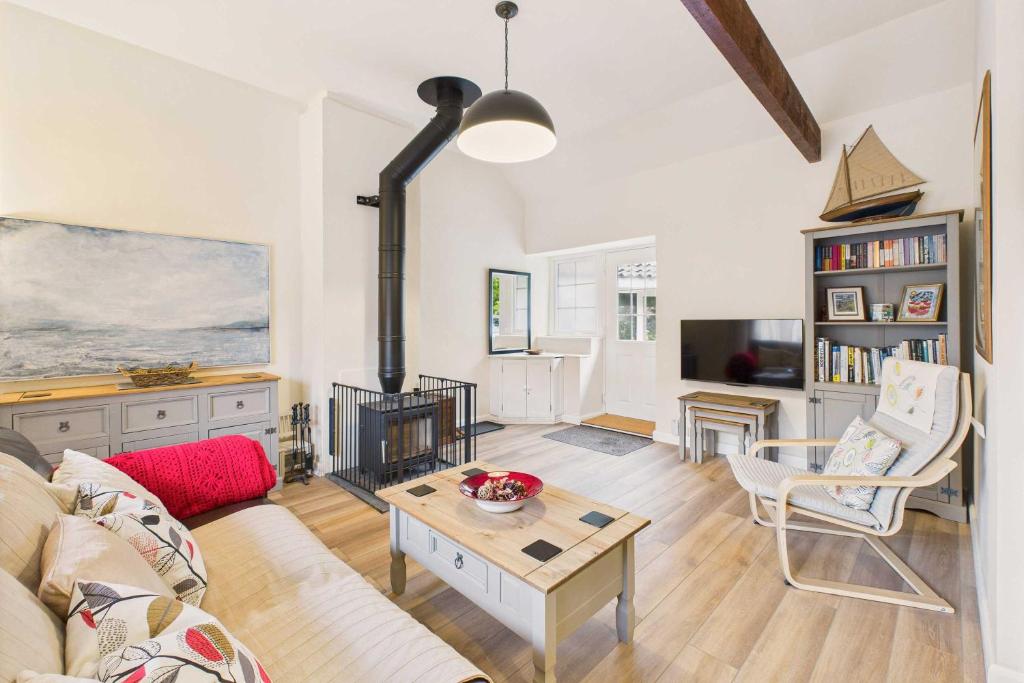 a living room with a couch and a table at Host & Stay - Lane Farm Cottage in Easington
