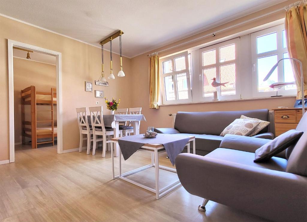 una sala de estar con un sofá y una mesa en Inselresidenz Strandburg Juist Ferienwohnung 50955, en Juist