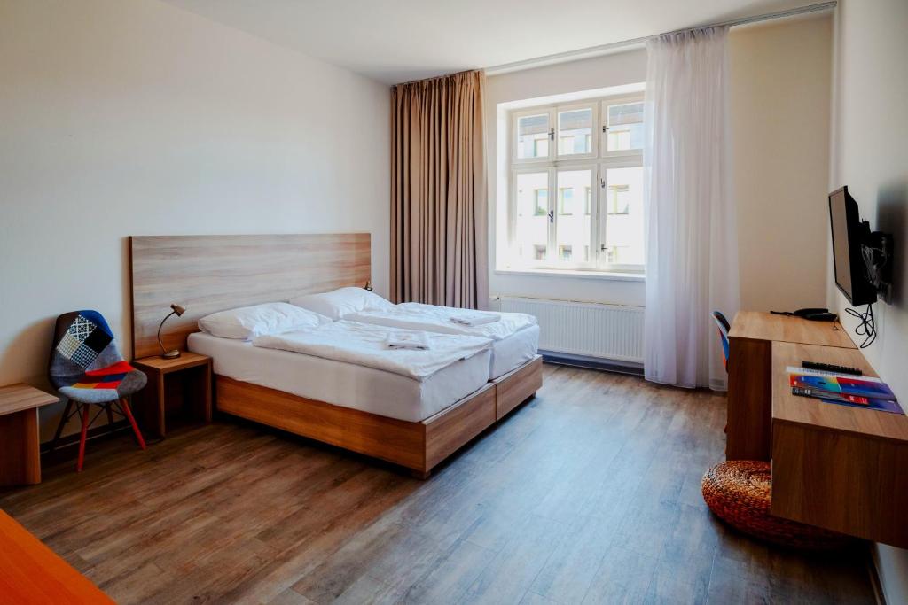 Postel nebo postele na pokoji v ubytování Hotel Palác Elektra