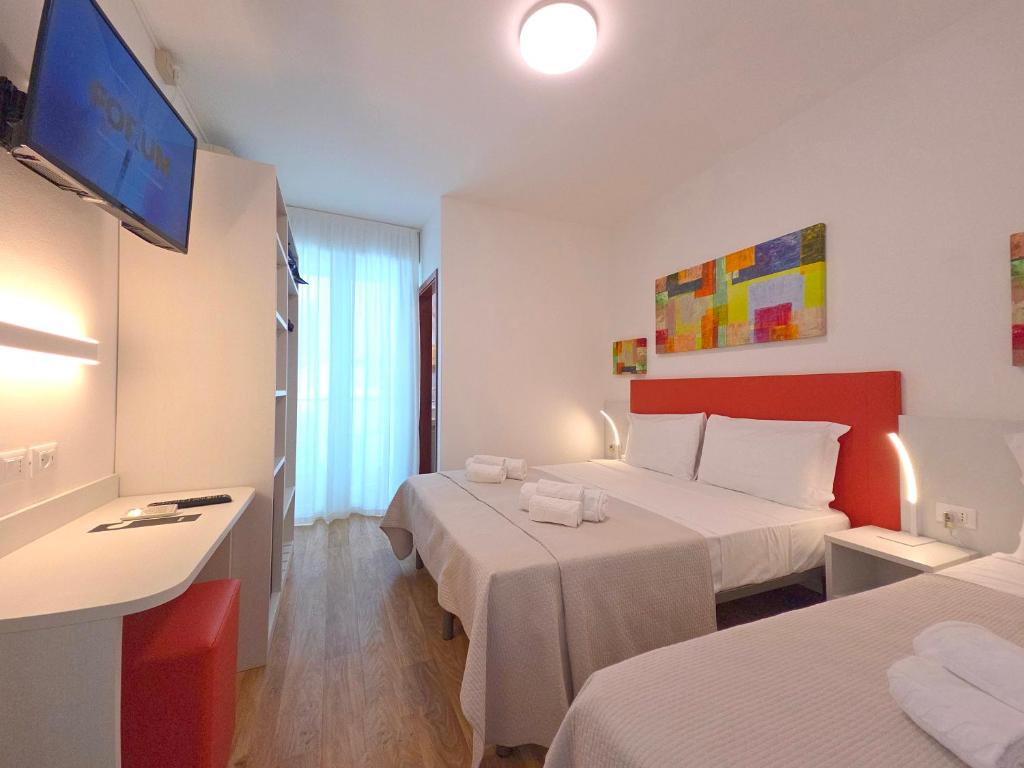 Posteľ alebo postele v izbe v ubytovaní Hotel Royal Garnì
