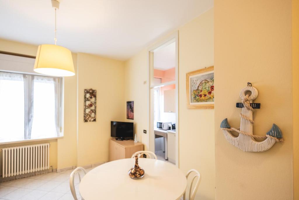 a dining room with a white table and a window at Marty Sweet Home, Cattolica Centro in Cattolica
