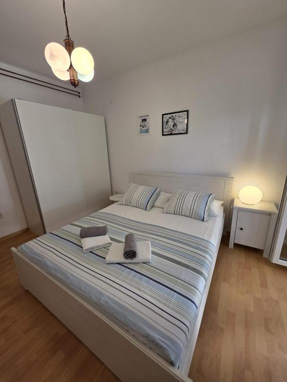 Postel nebo postele na pokoji v ubytování Apartmani Eta