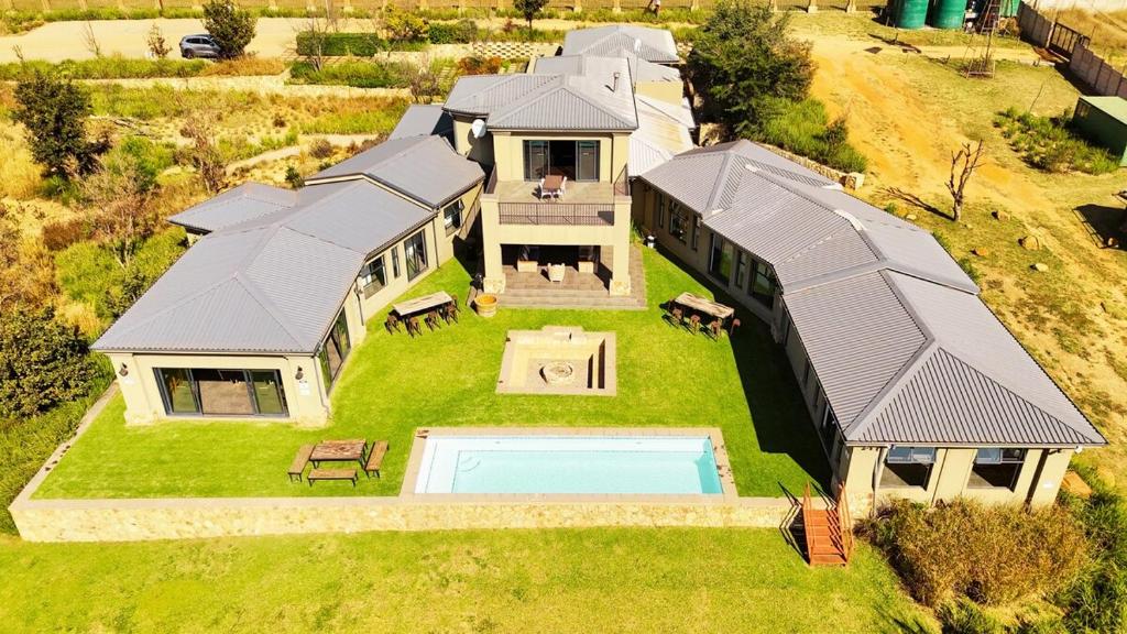 an aerial view of a house with a swimming pool at Stone`s Throw Manor in Muldersdrift
