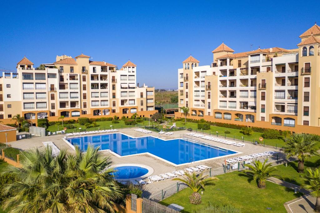 an aerial view of a large apartment complex with a swimming pool at Los Pelicanos by Ĥ - Playa Punta del Moral PLHC39P38 in Isla del Moral