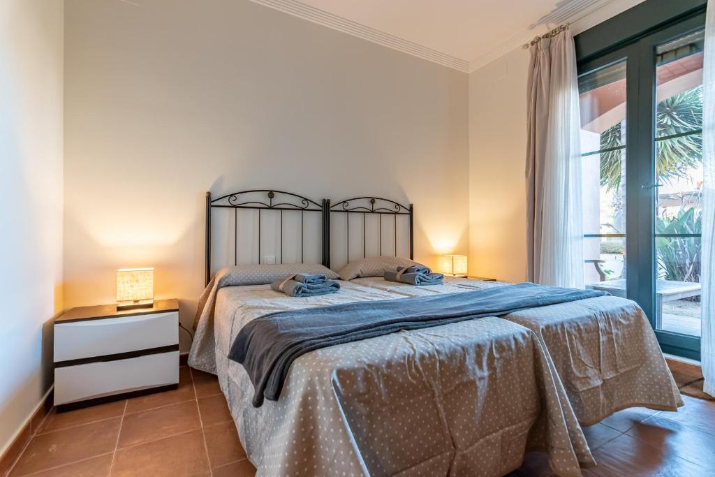 A bed or beds in a room at El Rincon del Golf II by Ĥ - Isla Canela Golf GRHII18P21