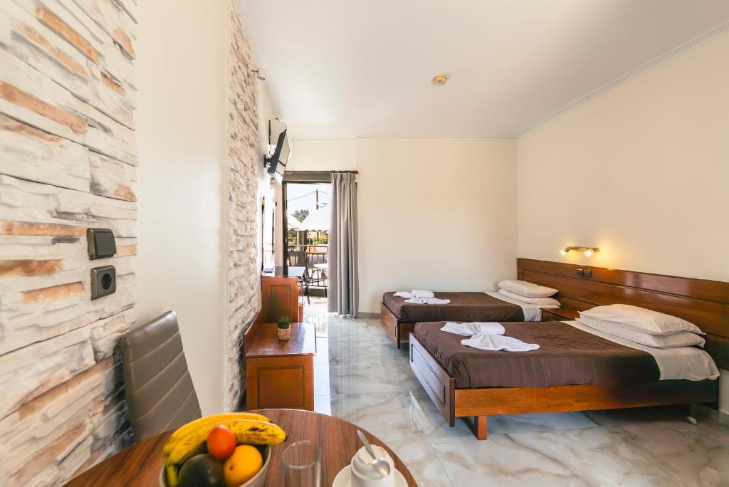 A bed or beds in a room at Maria's Beach Apartments
