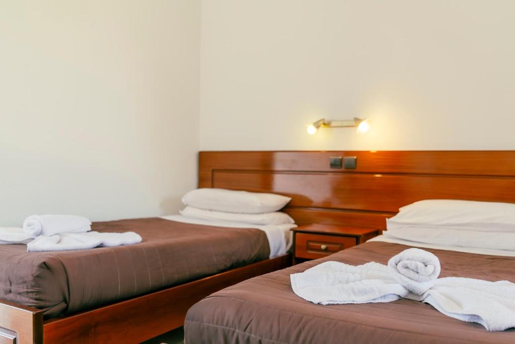 A bed or beds in a room at Maria's Beach Apartments