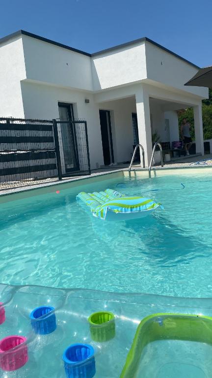 a swimming pool with colorful buoys in the water at Villa Emerald in Šiljkovača