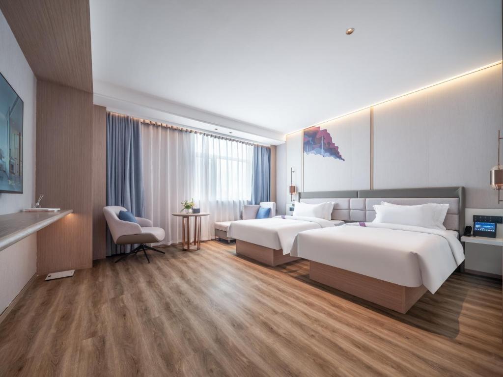Postel nebo postele na pokoji v ubytování Elong Hotel City Hall Branch