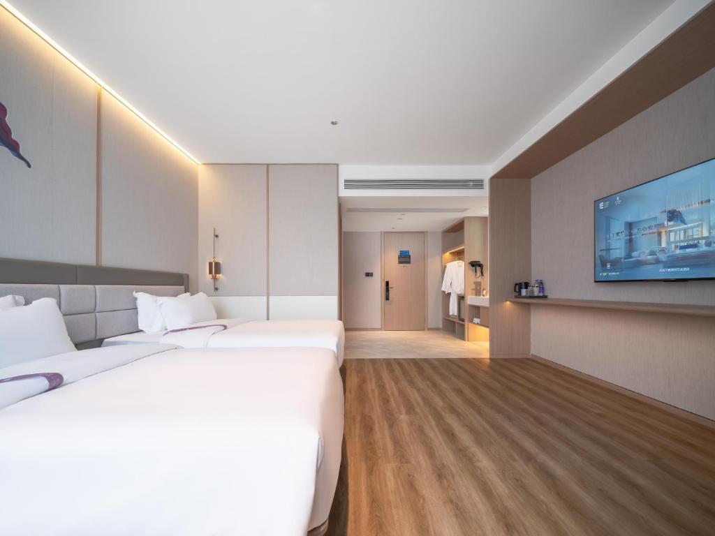 Postel nebo postele na pokoji v ubytování Elong Hotel City Hall Branch