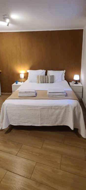 a bedroom with a large bed with two night stands at Habitación con baño y cocina en Marín in Marín
