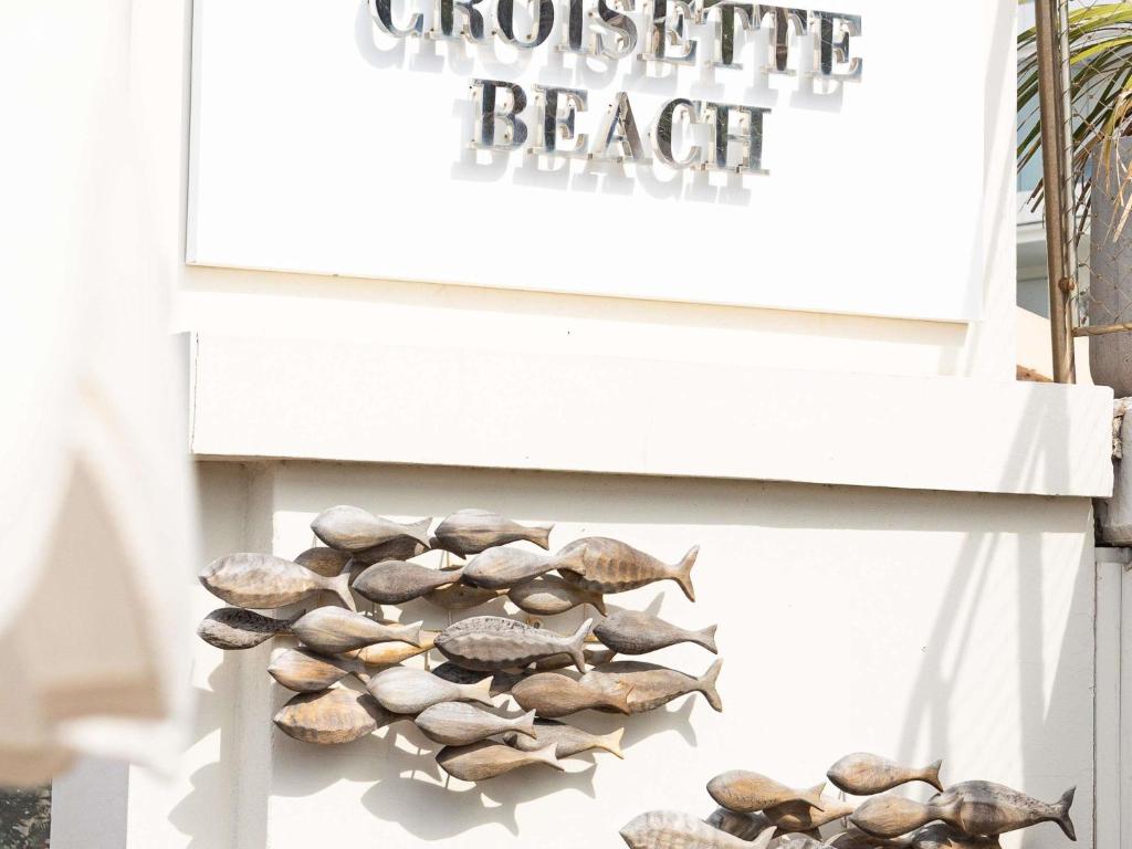 a bunch of seashells on a white bench at Croisette Beach Hotel Cannes - MGallery Collection in Cannes