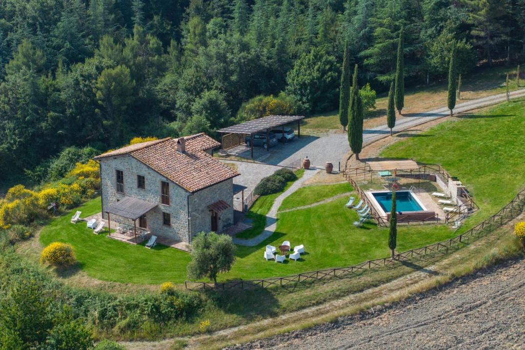 an aerial view of a house with a pool at Villa San Michele by PosarelliVillas in Campiglia dʼOrcia