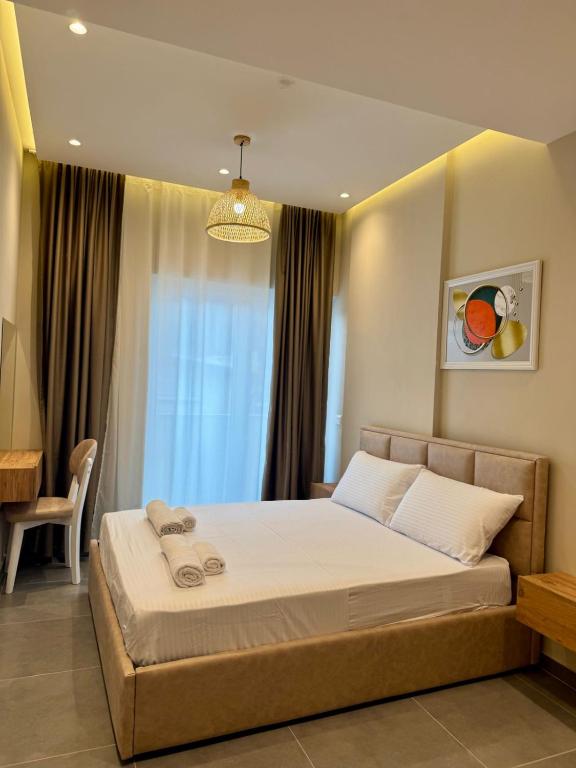 a bedroom with a large bed in front of a window at Apartamente Antoni Shengjin2 in Shëngjin