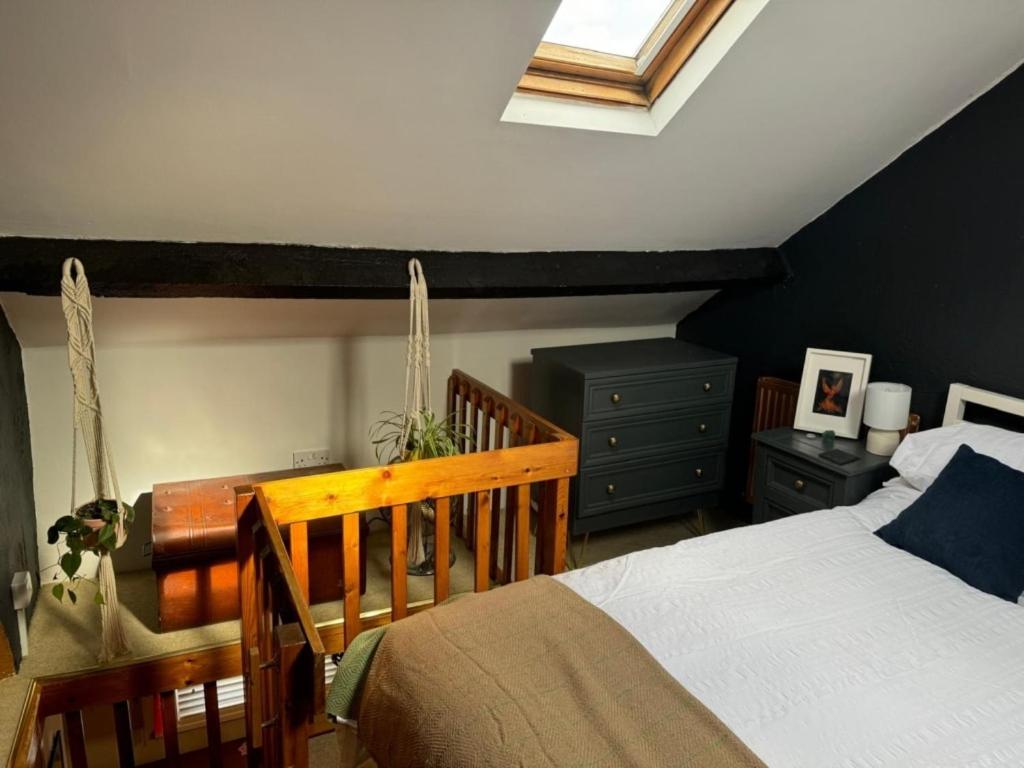 a bedroom with a bed and a skylight at Little Hive in the Heartlands in Glastonbury