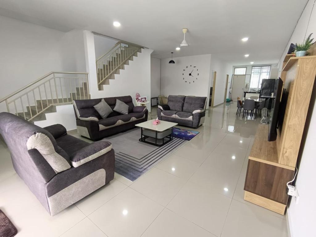 a living room with two couches and a table at 10-14Pax Port Dickson 4BR Rara homestay in Port Dickson