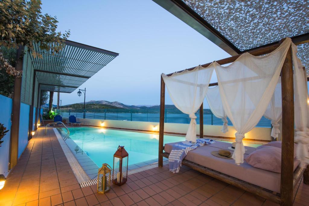 a bedroom with a canopy bed next to a swimming pool at SALTY BREEZE Beachfront Villa in Lygia