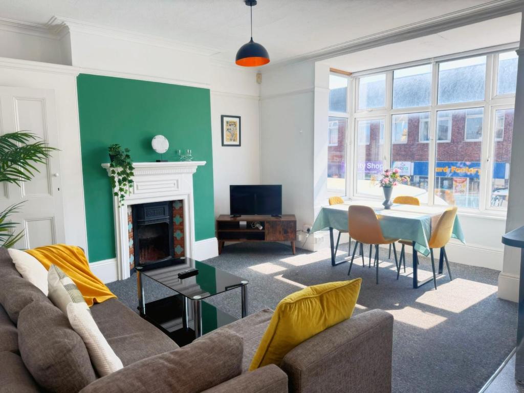 a living room with a couch and a table at Portslade Station House in Brighton & Hove