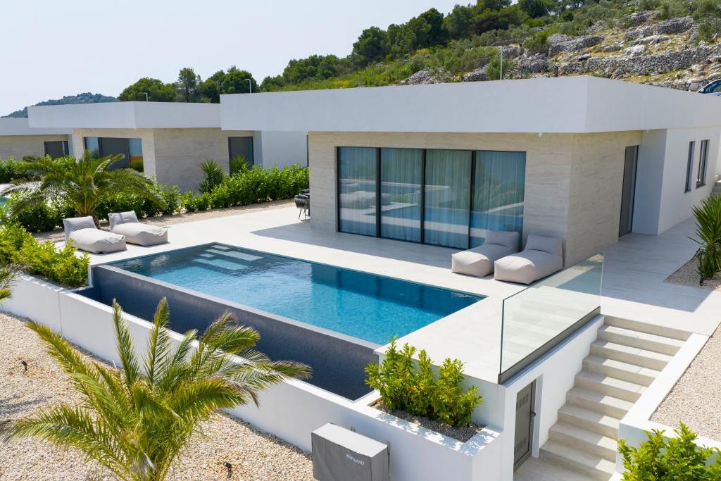 a villa with a swimming pool and a house at Cloud 9 D3 in Tkon