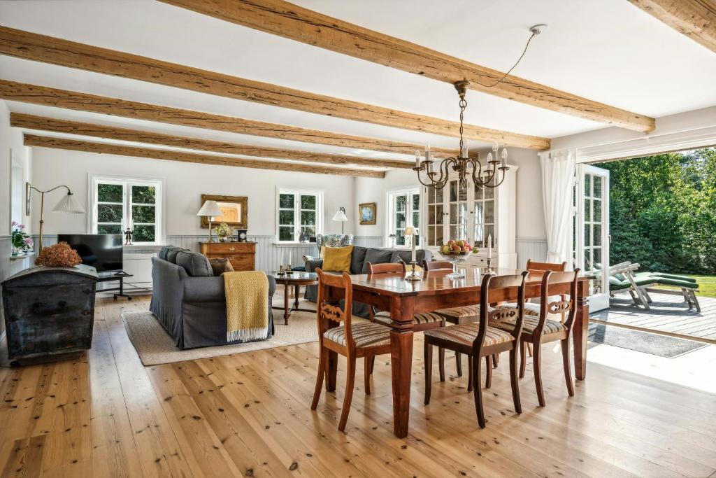 LjungbyhedにあるClassic Home In Peaceful Oasisのテーブルと椅子のあるダイニングルームとリビングルーム