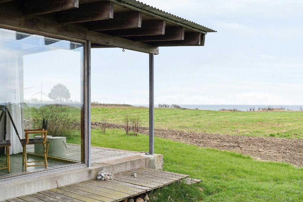 a porch of a house with a view of the ocean at Family Time At Sea Air Nature By Ebeltoft Bay in Ebeltoft