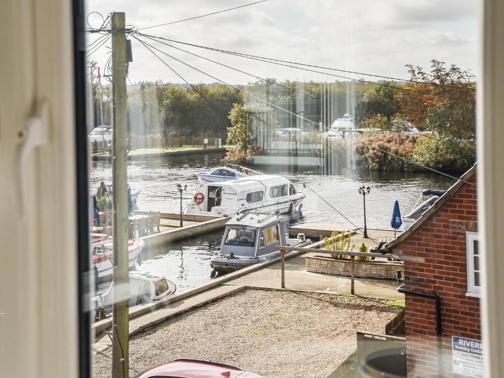 a view of a marina with boats in the water at River View in Horning