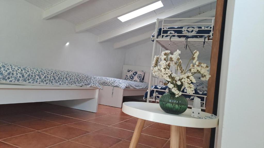 a room with a bed and a table with a plant at LA CRUZ DE LA ATALAYA in Benamahoma