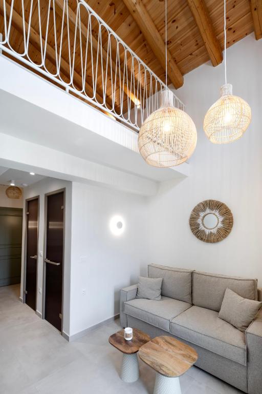 a living room with a couch and a table at Olive Dryopis Apartments in Kithnos