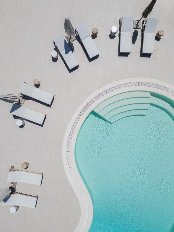 an overhead view of a swimming pool in a hotel at The Mykonian Escape in Mikonos