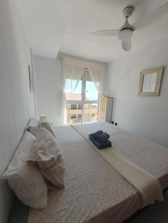 A bed or beds in a room at Alquilaencanarias-Medano, Cabezo beach, sea views!