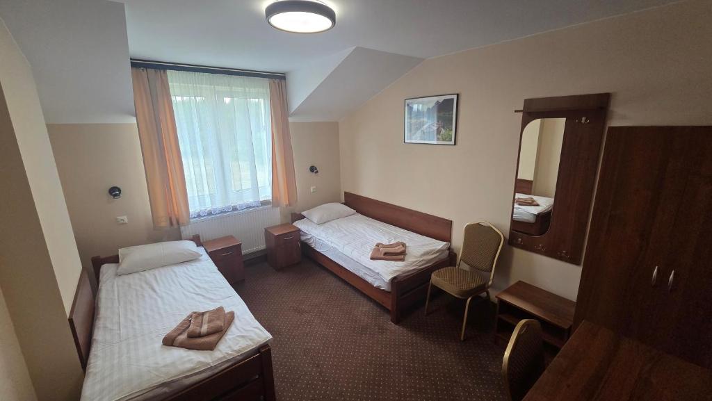 Łóżko lub łóżka w pokoju w obiekcie Hotel-Restauracja-Bar Rudka