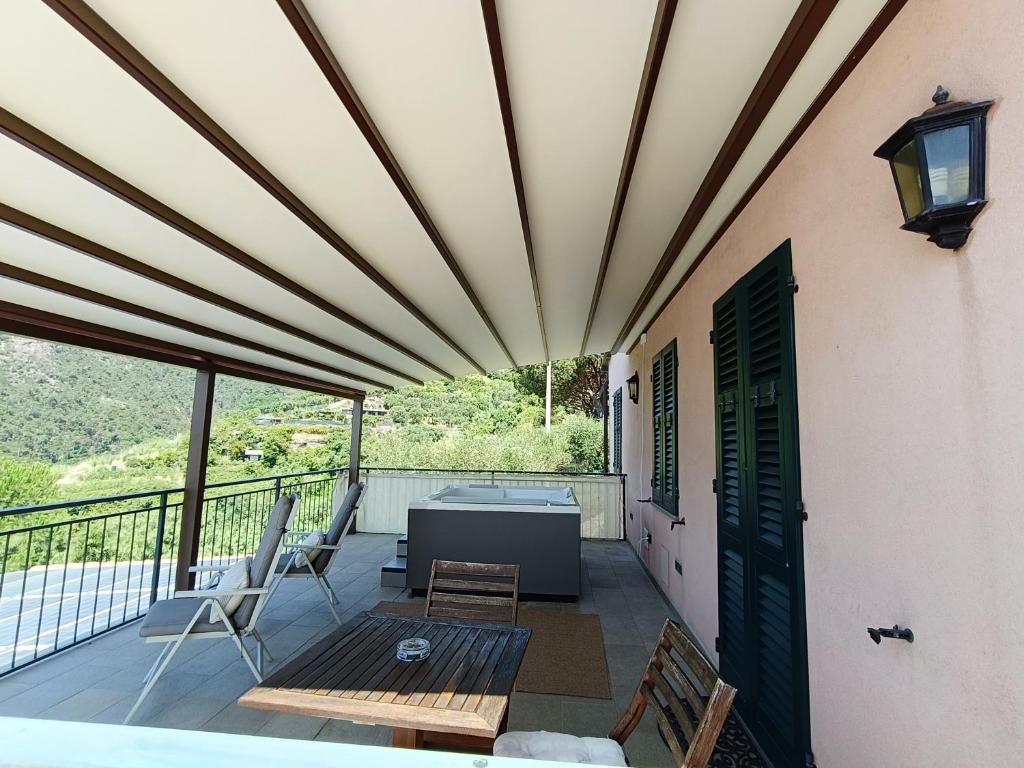 a patio with a table and chairs on a balcony at La Cabana Cinque Terre Monterosso in Monterosso al Mare
