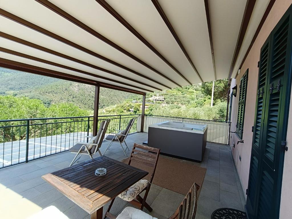 a patio with a table and chairs on a balcony at La Cabana Cinque Terre Monterosso in Monterosso al Mare