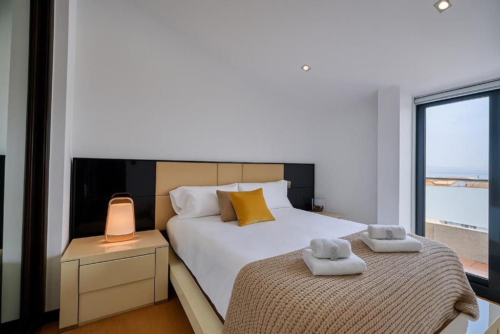 Postel nebo postele na pokoji v ubytování Faro de Corrubedo by Serendipia Turismo