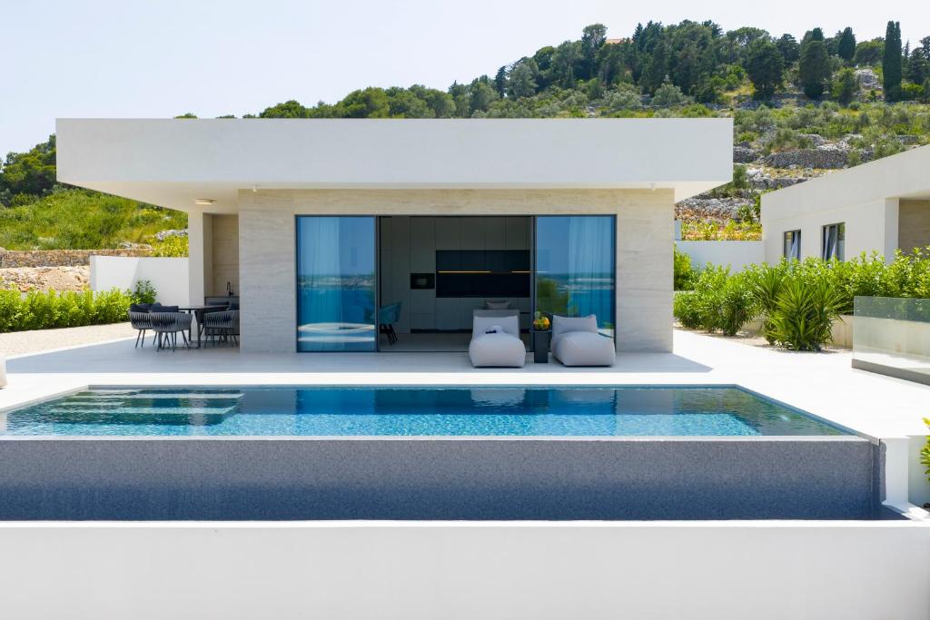 a villa with a swimming pool in front of a house at Cloud 9 D5 in Tkon