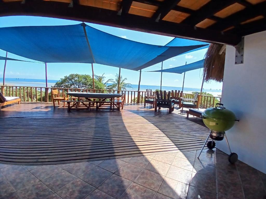 a deck with a ping pong table and benches at Seadeck, Barra Mozambique in Inhambane