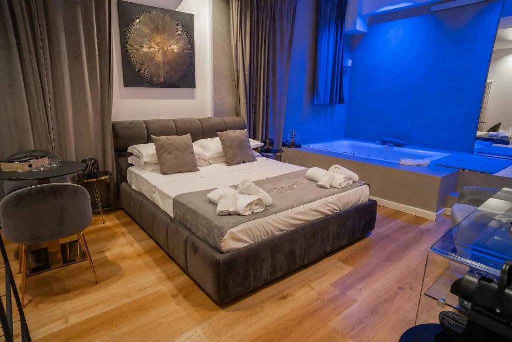 a bedroom with a bed with towels on it at Four Luxury Suite in Palermo