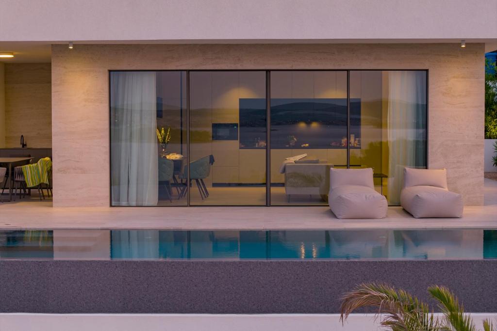 a house with a pool in front of it at Cloud 9 D7 in Tkon