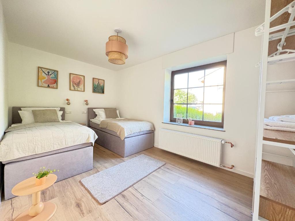 a bedroom with two beds and a window at Ferienwohnung direkt am Wasser in Lahnstein