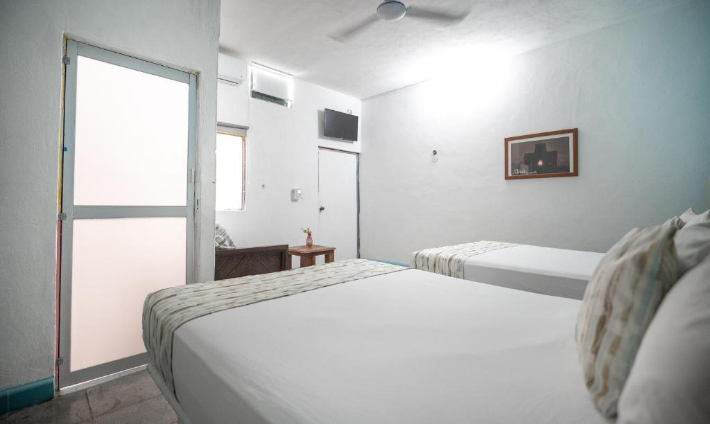 Postel nebo postele na pokoji v ubytování Hotel Posada Aurora