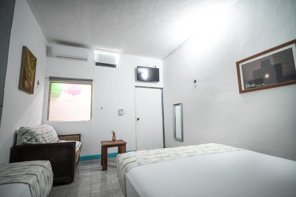 Postel nebo postele na pokoji v ubytování Hotel Posada Aurora