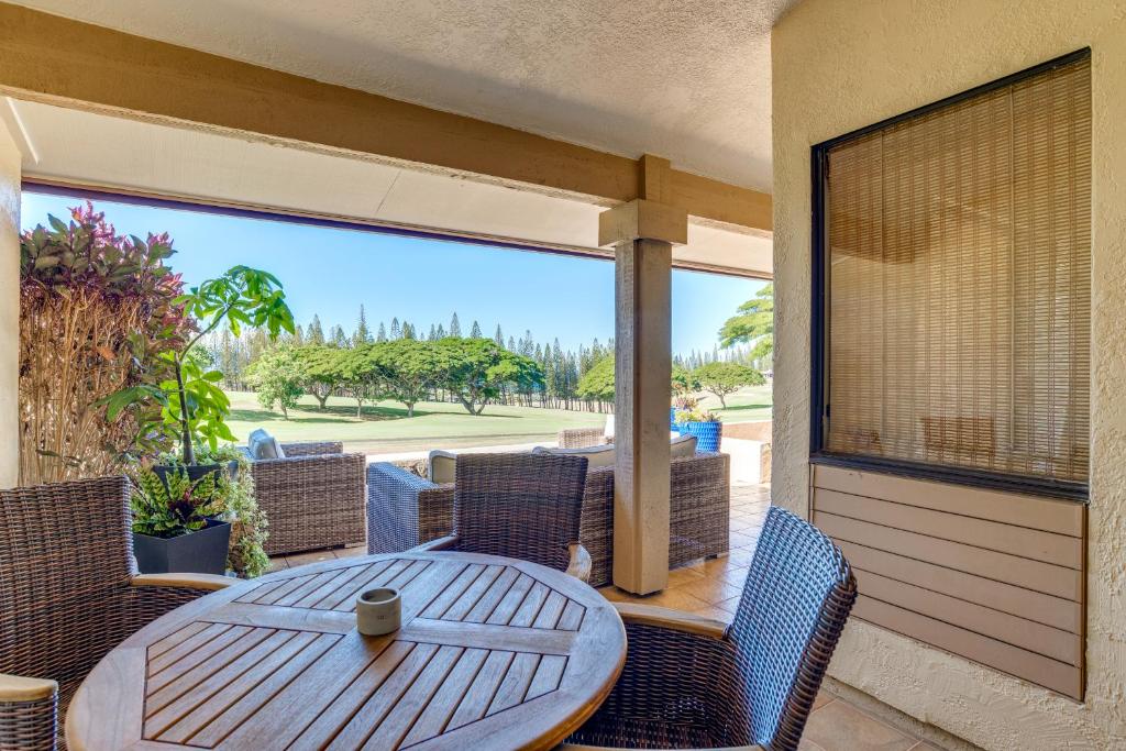 a patio with a wooden table and chairs and a window at Kapalua Golf Villas 15P3-4 in Kahana