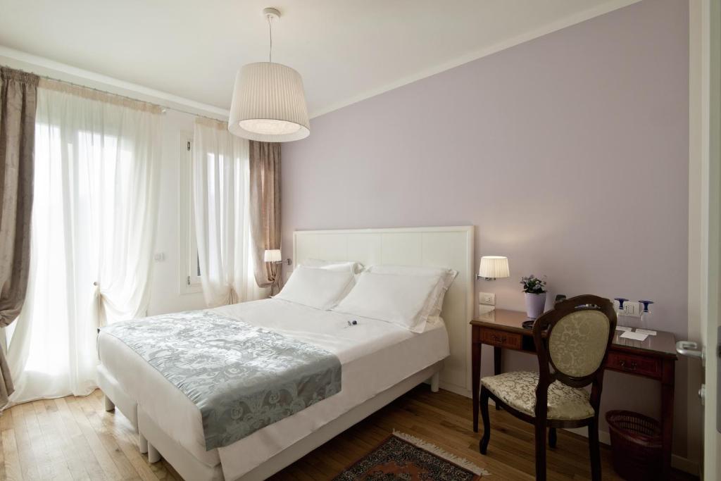 Postel nebo postele na pokoji v ubytování Chiara - Lodge