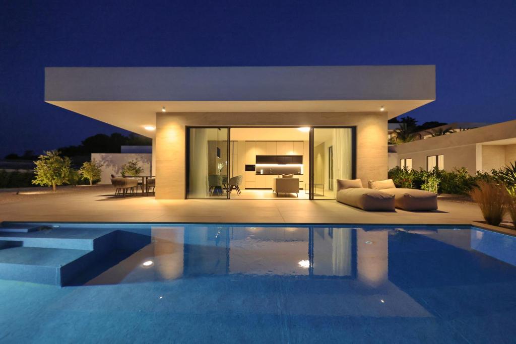 a villa with a swimming pool at night at Cloud 9 D9 in Tkon