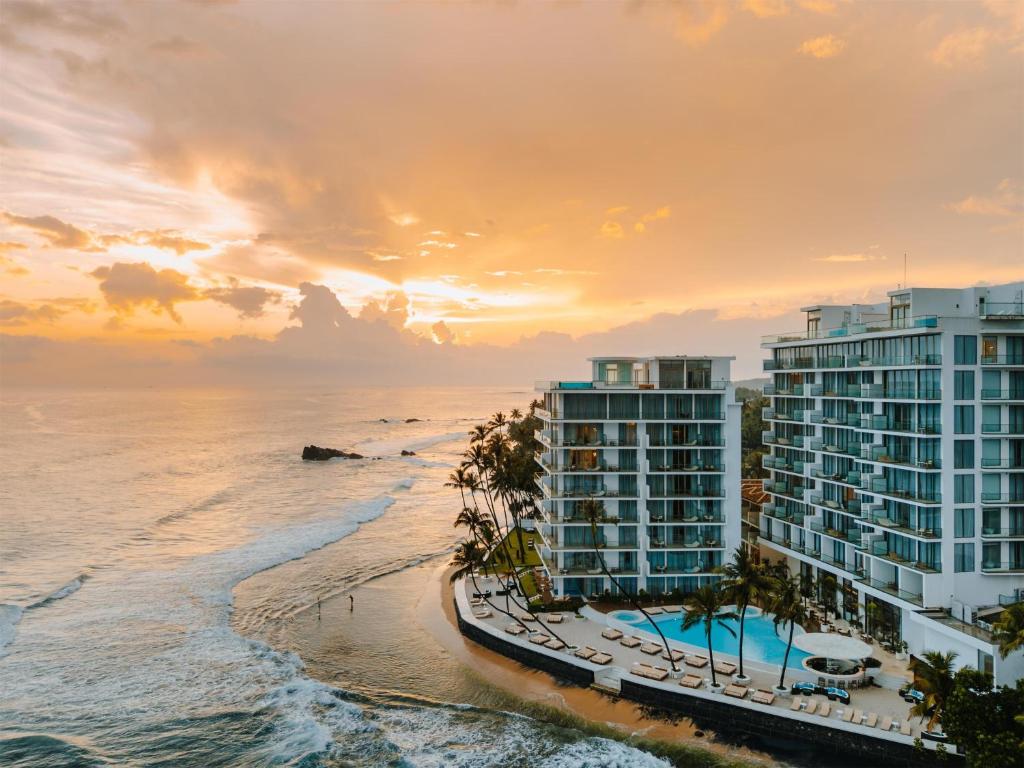an aerial view of a resort on the beach at sunset at Radisson Collection Resort Galle in Galle