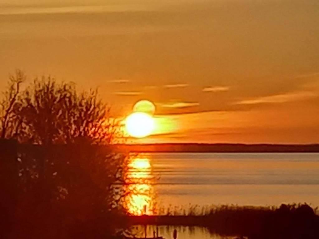 a sunset over a body of water at Fewo Abendsonne in Ueckeritz